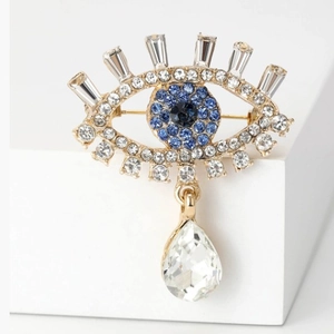 Luxury Evil Eye brooch with blue crystals and hanging pear-shaped drop pendant