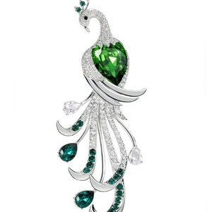 Luxury peacock brooch with green heart gemstone and white crystals in silver finish