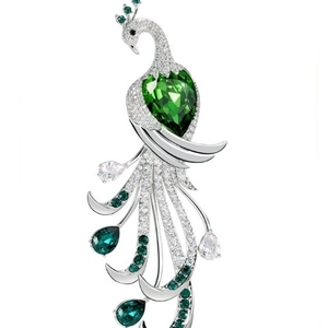 Elegant peacock brooch with green gemstones and white crystals on silver alloy finish