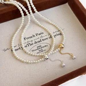Minimalist pearl necklace with brushed metal balls and tassels in gold and silver options