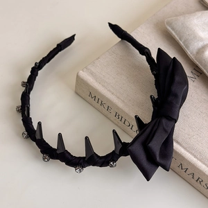 Black satin wave headband with teeth and bow design for high crown hair styling