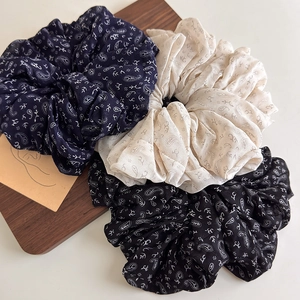 Three-piece set of retro paisley pattern oversized scrunchies in navy, beige, and black