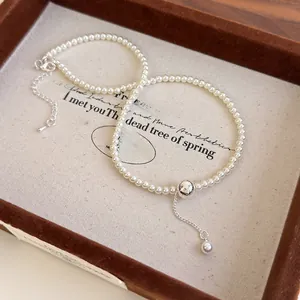 Detail of pearl necklace with hammered silver ball and elegant dangling tassel