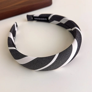 Detail of the black and white striped sponge headband with handmade woven fabric texture