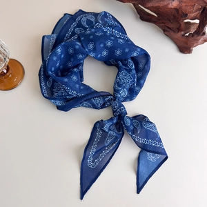 Detail view of navy blue paisley print scarf with a soft cotton-linen touch and drape