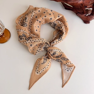 Detailed view of paisley printed cotton neck scarf tied in a stylish knot