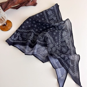 Close-up of black paisley pattern on cotton-linen feel scarf with vintage ethnic design