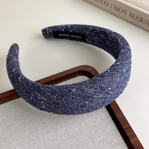 Detailed view of handmade blue tweed headband with soft sponge and textured woven fabric