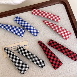 Set of 8 vintage gingham and solid color fabric hair clips for women in a wooden tray