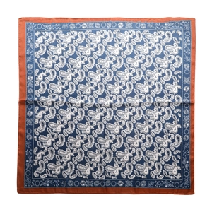 Square silk-like scarf with blue paisley pattern and orange borders laid on white background