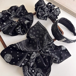 Detail of 4-piece vintage paisley hair accessories set with headband and scrunchie