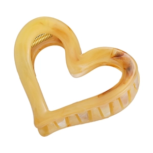 Amber marble heart-shaped hair claw clip with yellow resin texture and gold spring