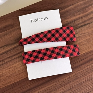 Detail of red and black buffalo plaid hairpin set with drop and rectangle shapes