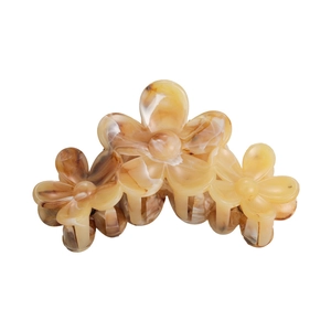 Detail view of the floral marble patterns on the amber brown hair claw clip