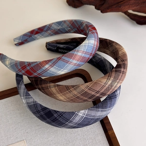 Detail view of Scottish style plaid padded headbands with handmade woven labels