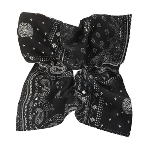 Detailed shot of black bandana with classic white paisley pattern and soft silk texture