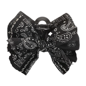 Close-up of black and white paisley print bow hair claw clip with sturdy spring detail