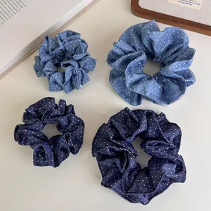Close-up of denim polka dot scrunchie set in light and dark blue cotton fabric