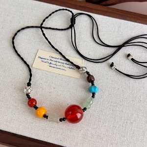 Detailed view of traditional Chinese beads with agate and silver lotus spacer