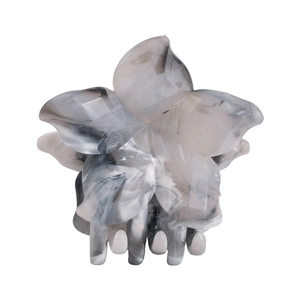 Macro detail of a large marble ink pattern flower hair claw clip with glossy finish