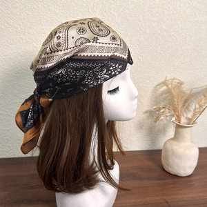 Detail of vintage paisley headscarf in black and brown satin with glossy finish
