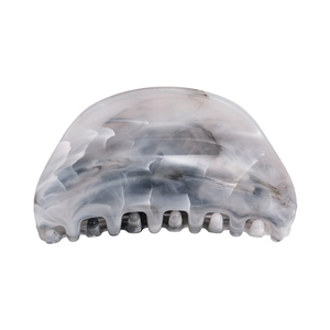 Macro detail of the grey ink marble texture and teeth of the large hair claw clip