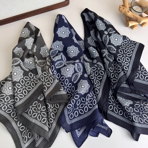 Three elegant geometric pattern silk scarves in dark grey, navy blue, and black colors