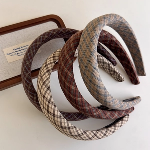 Classic plaid fabric headbands in retro earth tones with minimalist high-arch design style