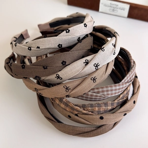 Detail showing various plaid and polka dot fabric headbands with bowknot designs