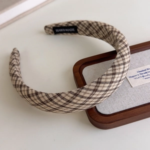 Detailed view of the handmade plaid fabric headband with a vintage brown checkered pattern