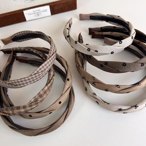 Elegant checkered bow headbands in grey and brown patterns with twisted fabric design