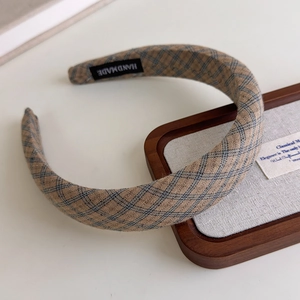 Detail of retro plaid headband featuring handmade label and blue-grey check pattern
