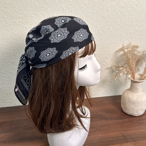 Detailed back view of vintage black square scarf with white floral patterns on a mannequin
