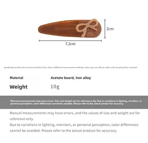 Detail view of brown acetate bow hair clip with size dimensions 7.2cm and France label