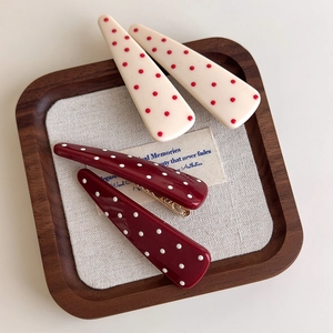 Polka dot hair clip set featuring teardrop design in red and beige resin material