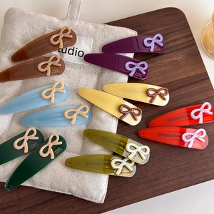 Handmade France style resin bow hair clips in various colors on a wooden tray