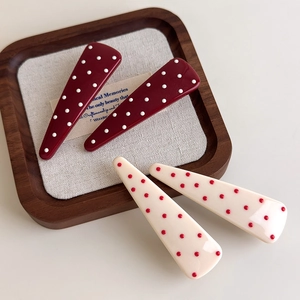 Retro red and white polka dot hair clips set of 4 on a vintage wooden tray display