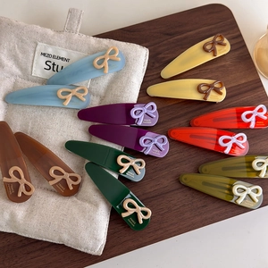 Detailed macro view of handmade French style acetate hair clips with bow decorations