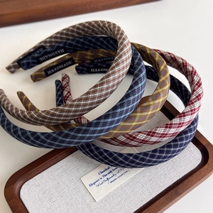 Detailed view of handmade vintage plaid headbands showing texture and label