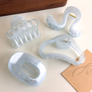 Set of four translucent cloud geometric hair claws with blue marble acrylic finish