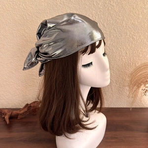 Detailed close-up of metallic silver bandana with reflective finish on model head
