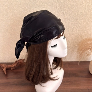 Detail view of a black shiny PU leather headscarf with retro Y2K streetwear style
