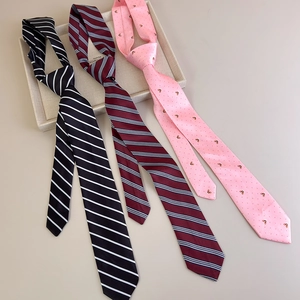Detailed view of pink puppy heart and striped ties in black, burgundy and pink