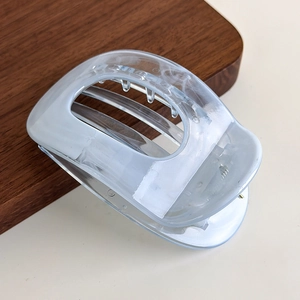 Close-up of translucent marble blue geometric hair claw clip with polished finish
