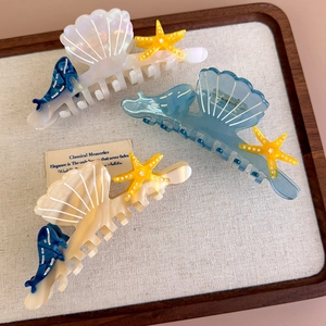 Large acetate ocean hair claws featuring starfish and shell designs in assorted colors