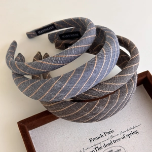 Three-piece striped fabric headbands in retro blue and grey with handmade label detail