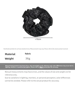 Detail view of 16cm vintage black printed hair scrunchie with weight and size parameters