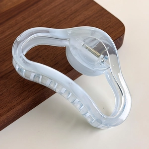 Detail of transparent marble wave hair claw clip with a strong metal spring