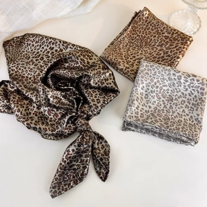 Detail of leopard print bandanas with metallic sheen in bronze gold and silver gray
