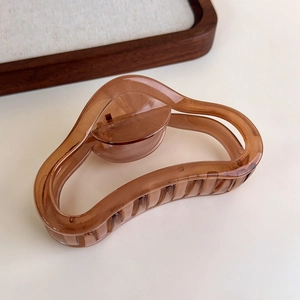 Detailed view of coffee brown wavy geometric hair claw clip with a resin finish